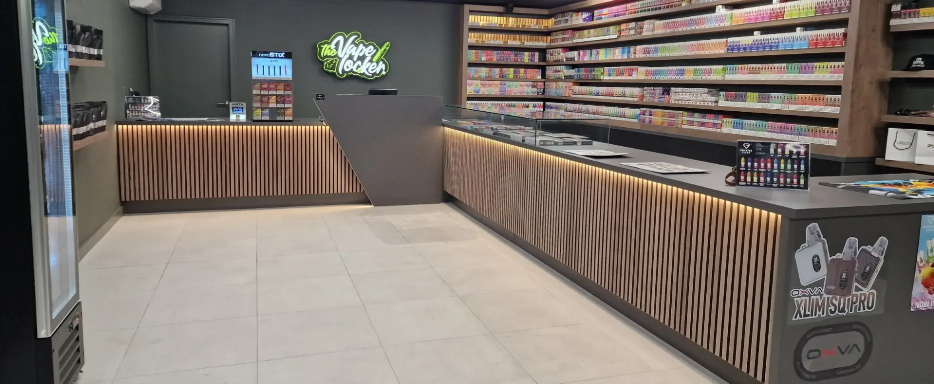 Timber-fronted retail counter and wall display at The Vape Locker